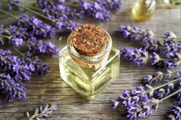 Obraz na płótnie Canvas A bottle of aromatherapy essential oil with fresh lavender flowers