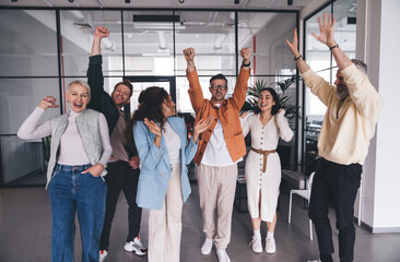 Diverse team celebrating success in workspace