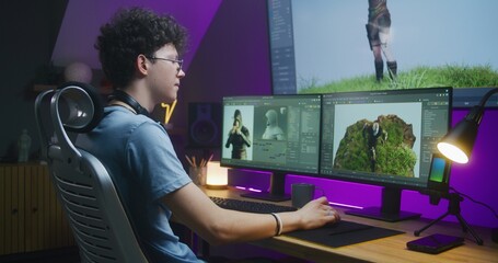 Young 3D designer draws video game character, creates animation. Teenager works remotely at home on computer and big digital screen with professional software interface for 3D modeling and design. - obrazy, fototapety, plakaty