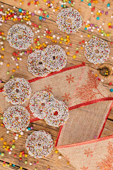 Colored chocolate rings with Christmas decoration on wood table
