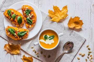 Pumpkin cream soup. Vegan healthy food. Breakfast or brunch on white wooden background.