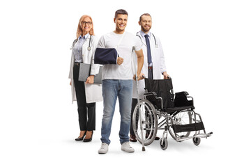 Fototapeta na wymiar Young man with arm and leg injury standing with a team of doctors