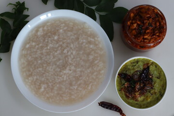 Kanji and Kadumanga. Rice gruel prepared with Kerala Matta rice. Served with raw banana curry and Kerala style cut mango pickle.