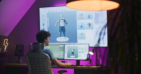 Young 3D designer creates video game character or clothes, works remotely from home in the evening...