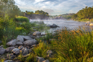 The river South Buh is at dawn in fog.