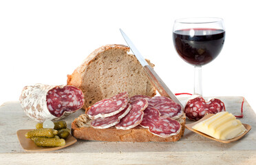 saucisson, bread and butter in front of white background