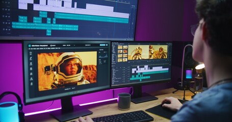 Young video maker edits movie about space mission, works at home office. Film footage and software...