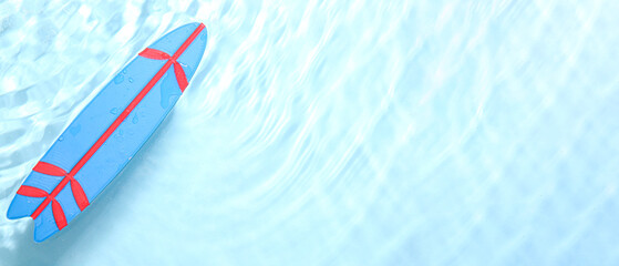 Blue surfboard on water surface, top view. Banner for design