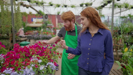 Male Flower Shop Employee Assisting Female Client_ Store Visit and Purchase with Apron