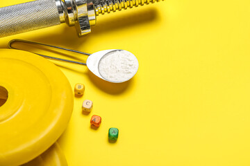 Barbell plates, grip and scoop of amino acid supplement on yellow background, closeup