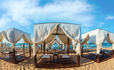 Luxury beach tents canopies on morning paradise white sandy beach The Maldives of Salento...