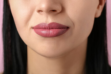 Fototapeta premium Woman with applied lipstick on pink background, closeup