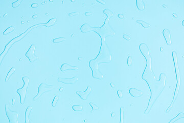 Water drops on blue background. Flat lay top view of blue water drops.Texture of water drops on pale blue background