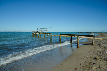 Beach in Heiligenhafen with sea view and old rotten wooden jetty