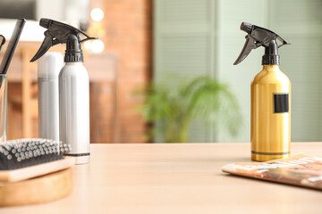 Bottles of spray on table in beauty salon