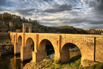 Fototapeta na wymiar Roman bridge of Alcantara. Dates from de II century B.C. It was very important over the history as a strategic point to cross the Tagus river during Roman domination period in Spain. Caceres, Extremad