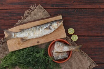 Mullet, Buri salt fish, Burai sea fish, on separate wooden board, top view, place for text, background, background image