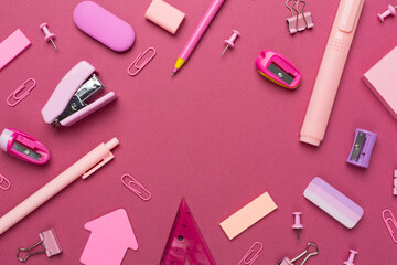 Pink school stationery on color backgroung, top view