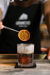 dried orange in drink bartender