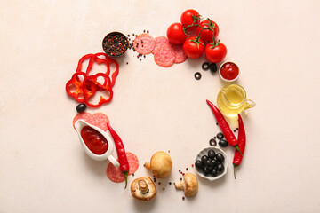 Frame made of fresh ingredients for preparing pizza on light background