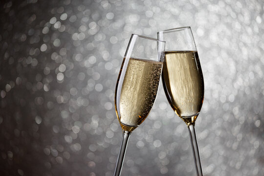 Picture of two wine glasses with champagne on gray background,bokeh effect