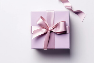 Gift box wrapped with craft paper and bow on neutral background with boke.