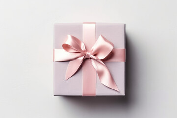 Gift box wrapped with craft paper and bow on neutral background with boke.