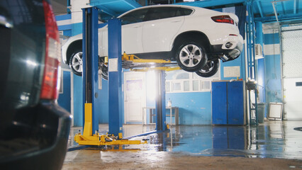 Luxury SUV in professional car service workshop - wide angle