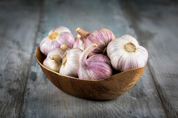 Close-up garlic bulbs and garlic cloves on wooden background. Garlic. Fresh garlic