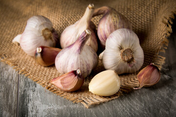 Close-up garlic bulbs and garlic cloves on wooden background. Garlic. Fresh garlic