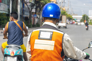 Moto taxi driver on the street, rear view, Thailand