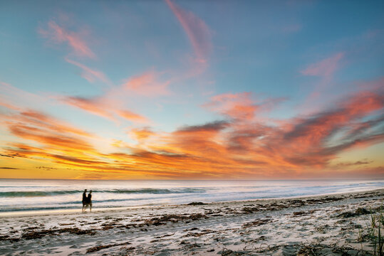 Beautiful seascape sunset over the sea with two romantic silhouette.  Australia near Perth