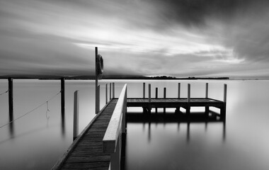 Long exposure and a timber jetty in black and white - obrazy, fototapety, plakaty