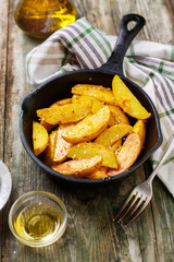 Oven-baked potatoes in a cast iron skillet