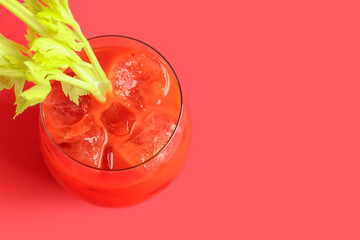 Glass of bloody mary with celery on red background - obrazy, fototapety, plakaty