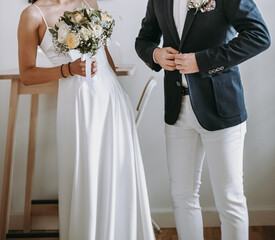 Groom wears blue suite and bride in white wedding dress. Bridal couple in love on a wedding day. - 615930778
