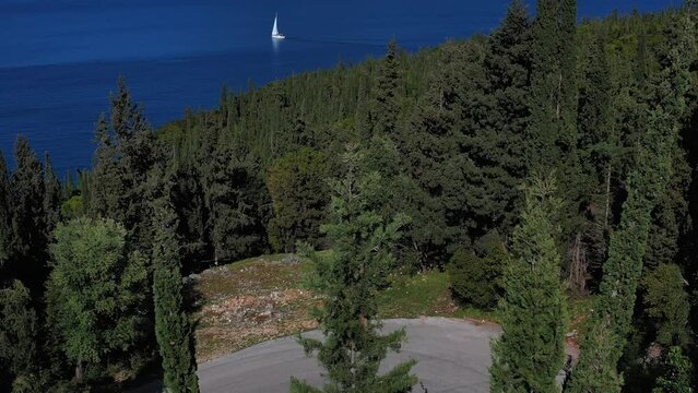 Drone 4k video with road cyclist on a scenic winding road on the island of Kefalonia, Greece 