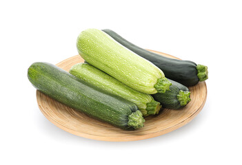 Plate with fresh green zucchini on white background