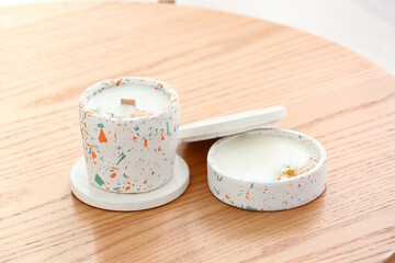 Holders with candles on table in room, closeup