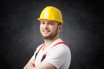 Happy, smiling worker with arms crossed looking at camera