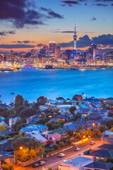Cityscape image of Auckland skyline, New Zealand during sunset with the Davenport in the foreground.