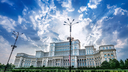 historic parliament of bucharest against a cloudy sky