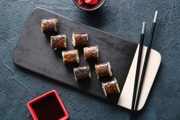Tasty maki rolls and soy sauce on dark background © Pixel-Shot