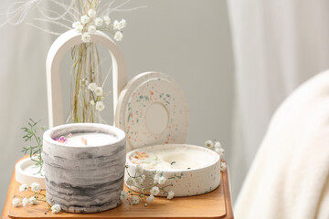 Gypsophila flowers and candles on table in living room, closeup