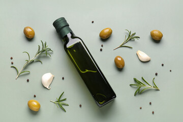 Bottle of olive oil on green background