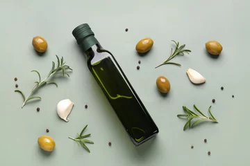 Fotobehang Bottle of olive oil on green background © Pixel-Shot