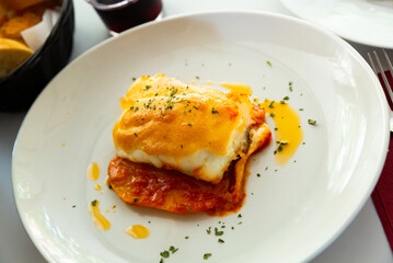 Closeup of codfish backed with sauces and served at plate