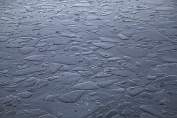 Shards of ice in the river water at winter.