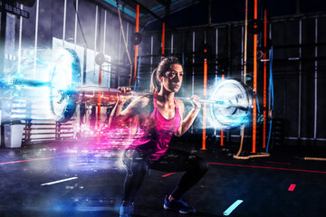 Determined athletic girl works out at the gym with a with blue energy effects