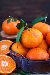 Fresh tangerines with leaves on  wooden table